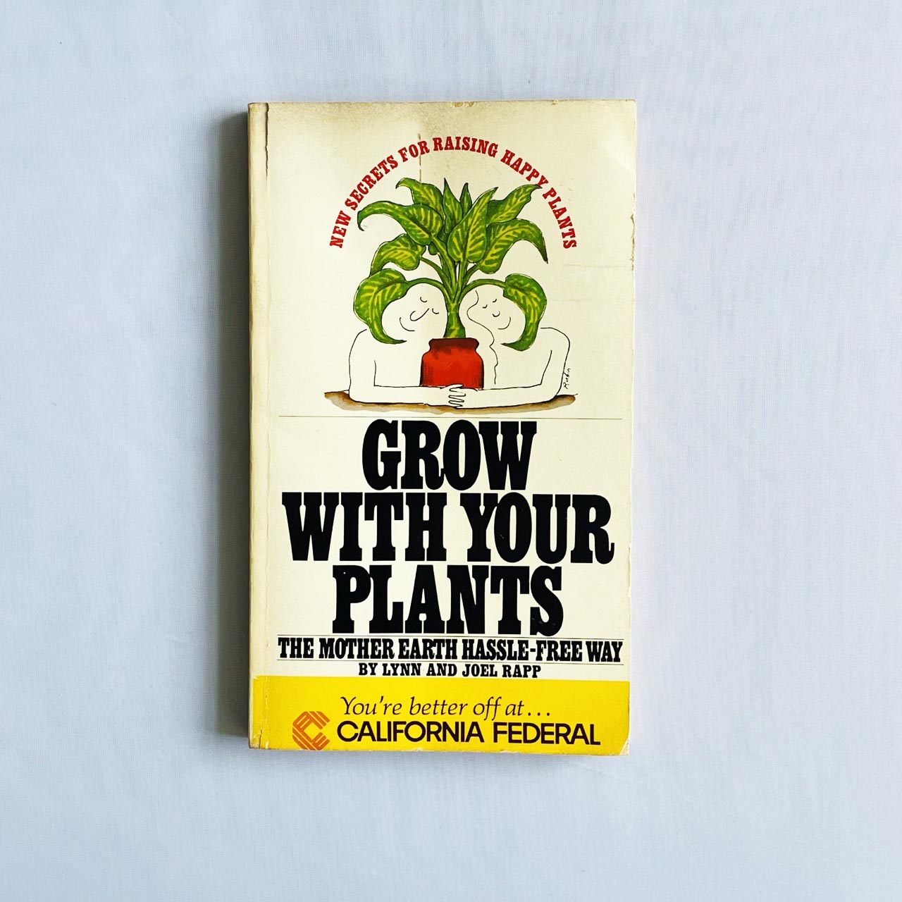 Grow With Your Plants the Mother Earth Hassle-Free Way book cover showing two people hugging a potted plant illustration.